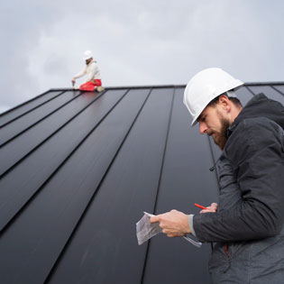 ouvriers travaillant sur l'étanchéité d'un toit