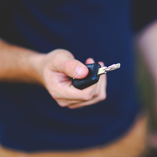 person holding a car key