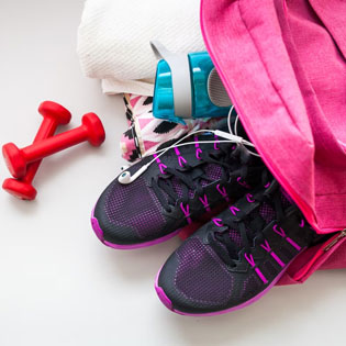sports shoes in a bag with dumbbells