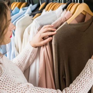 woman looking at a brown sweater