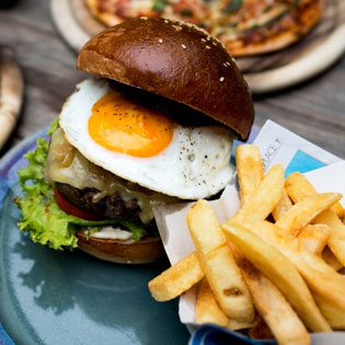 burger with an egg and french fries