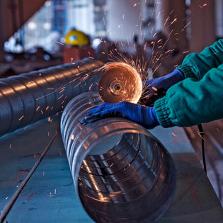 worker cutting steel pipe