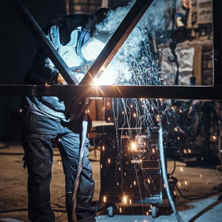 worker welding metal parts