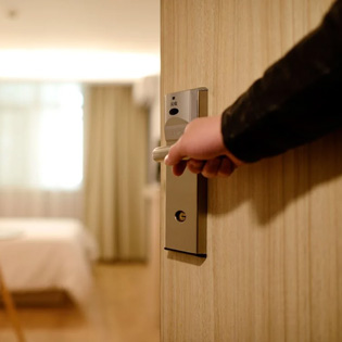 customer opening the door of an hotel room