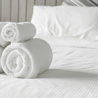 serviettes et draps blanc sur un lit