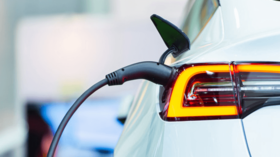 An electric vehicle being charged - illustrating the transformation of the automotive sector