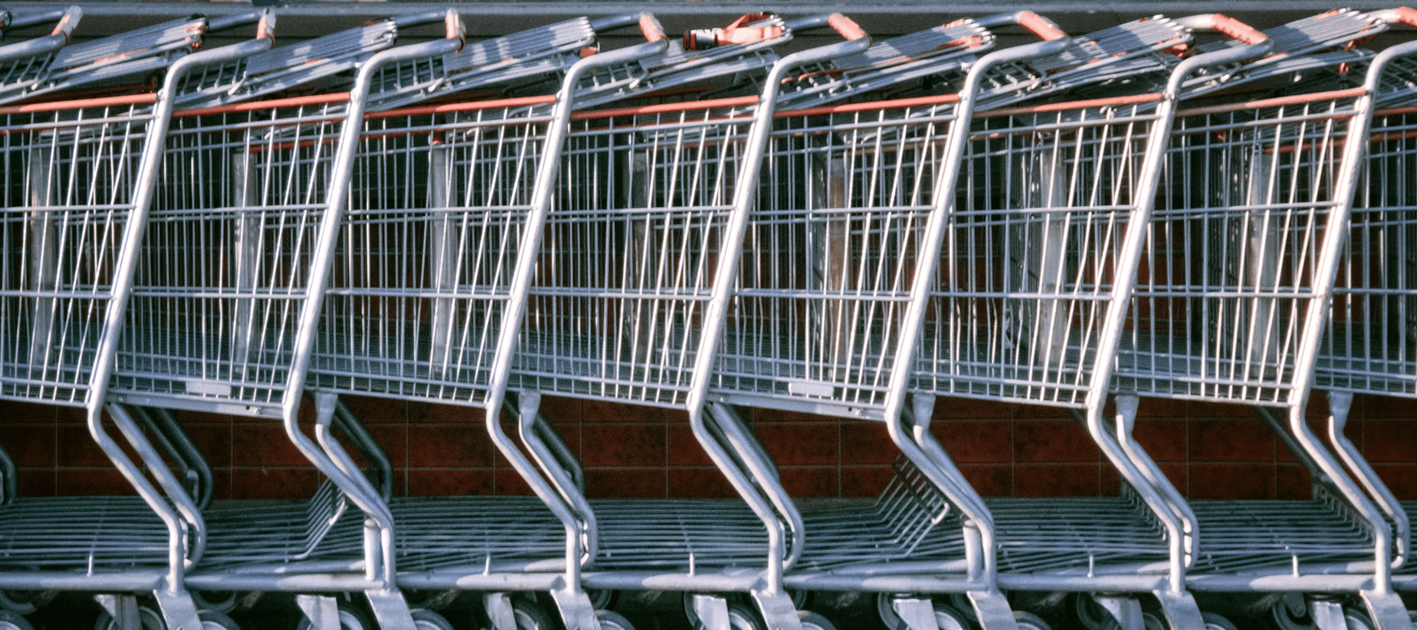 A row of supermarket shopping carts - illustrating the consumer goods sector