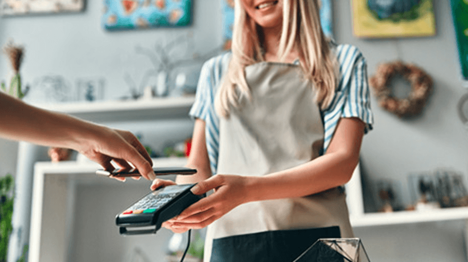 A customer using contactless payment at a point of sale