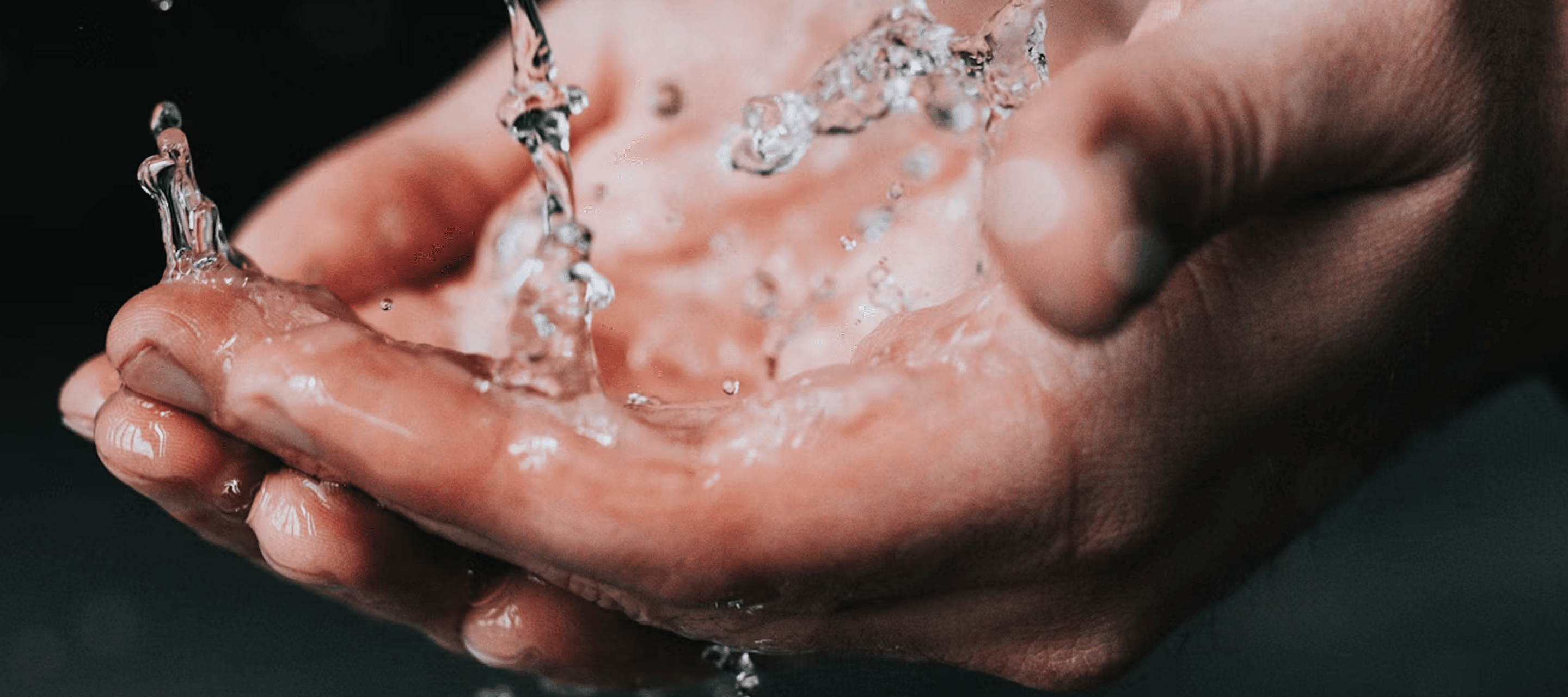 Hands cupping flowing water - illustrating the healthcare sector