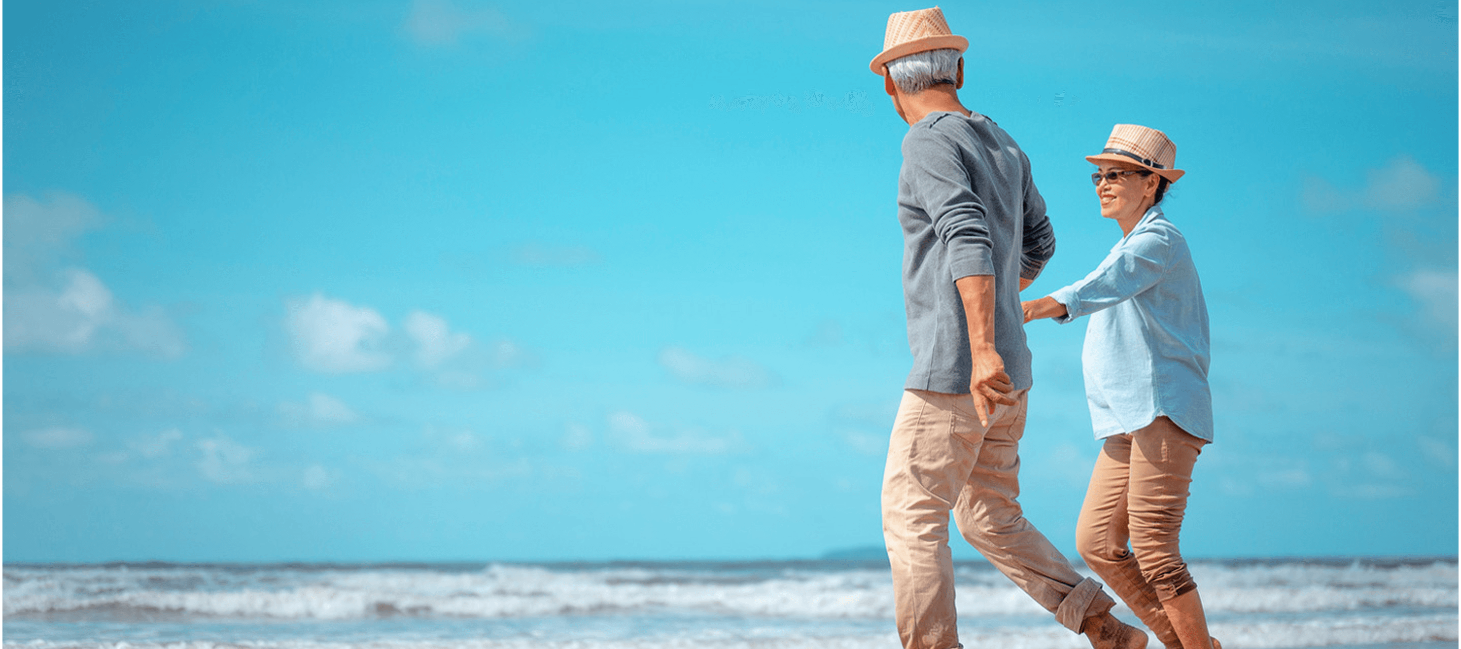 A senior couple walking along the seafront - illustrating the household services sector