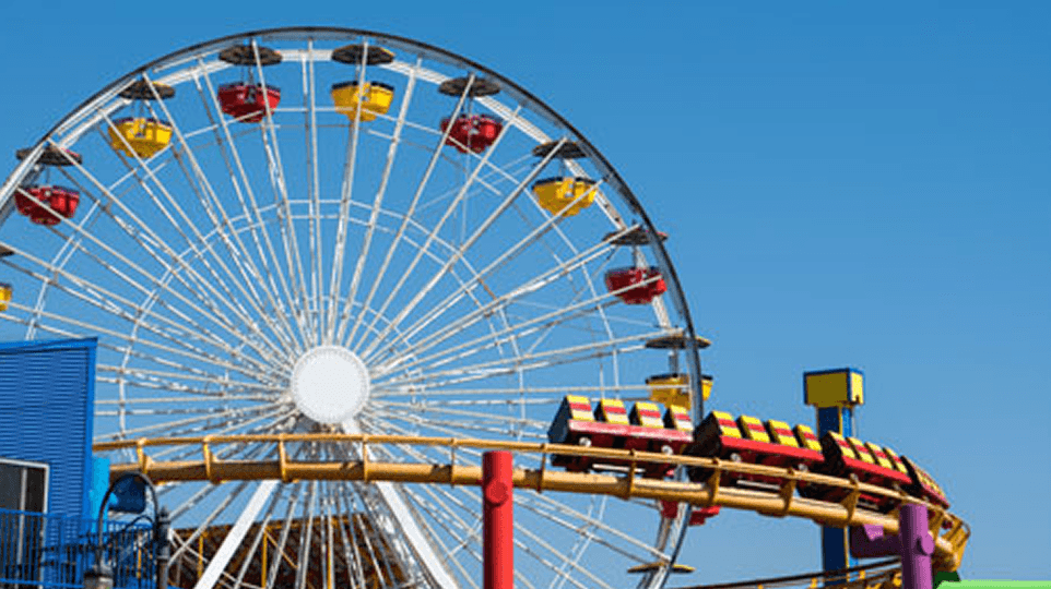 A Ferris wheel and amusement rides - illustrating the leisure sector